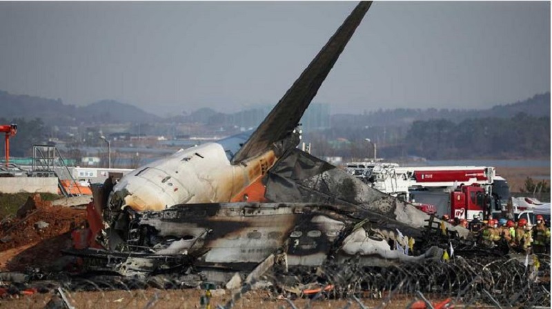 Rescue workers take part in a salvage operation at the site where an aircraft crashed after it went off the runway at Muan International Airport, in Muan, South Korea