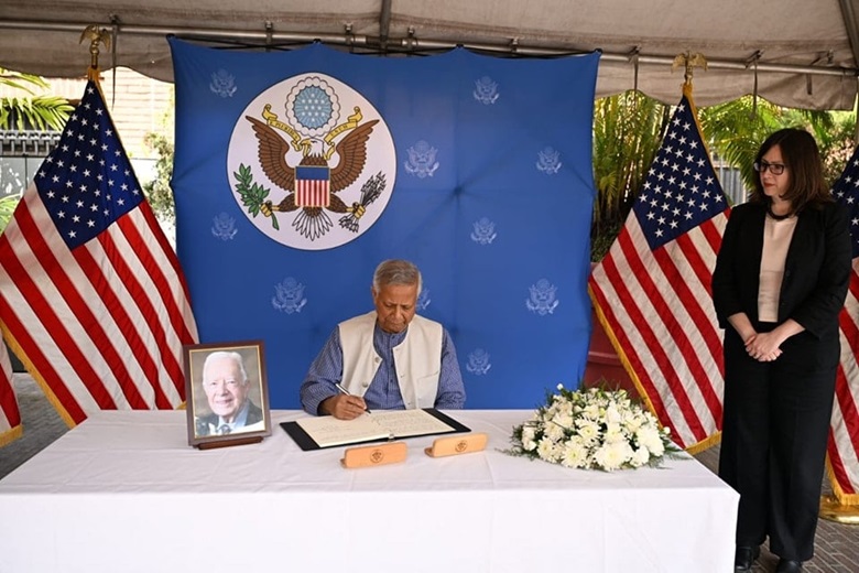 Chief Adviser Professor Muhammad Yunus signs on a condolence book paying profound tributes to former United States President and fellow Nobel Laureate Jimmy Carter at the US Embassy in Dhakaon Tuesday (December 31) 